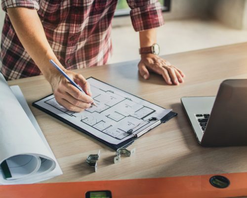 engineer planing and checking on blueprint on table background, real estate concept