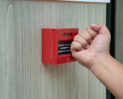 Fire alarm box with human hand action to crush the glass for emergency situation.